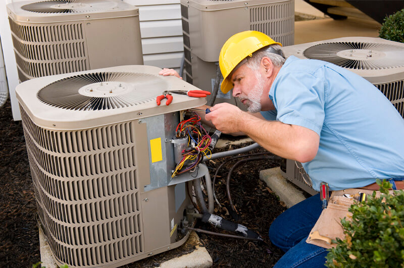 Technician providing air conditioning repair