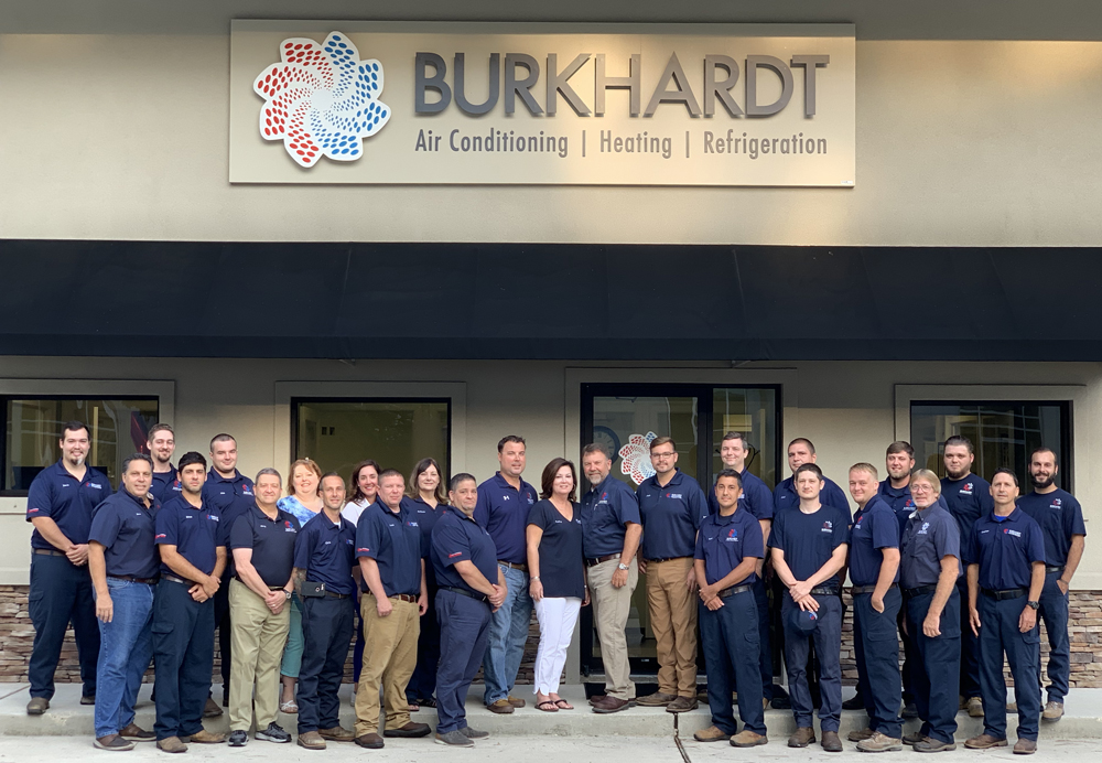 Burkhardt team in front of storefront with Burkhardt logo