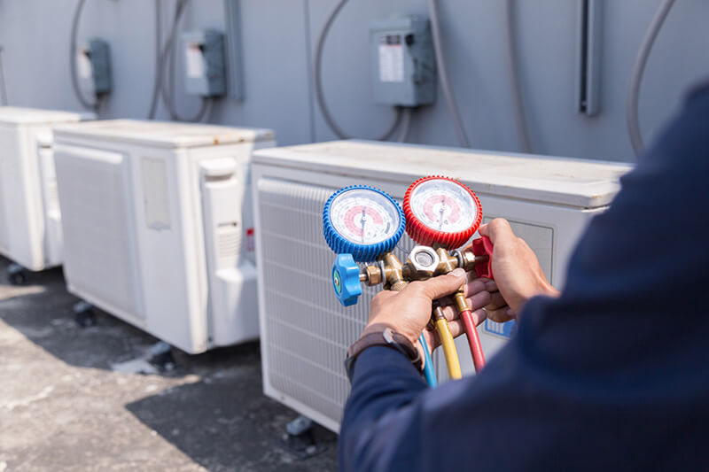 Commercial hvac technician adjusting a valve