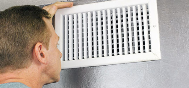 Person looking at vent giving off poor air temperature