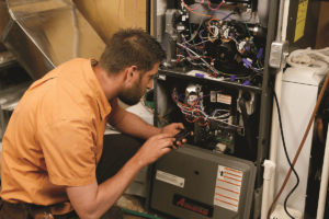 HVAC technician calibrating a furnace.