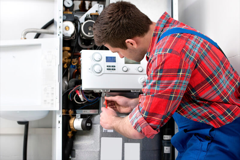 Technician maintains a heating system