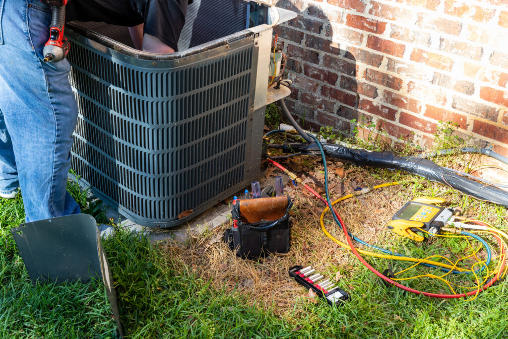 Technician providing air conditioning repair