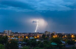 lightning strike over a city, in need of a powerful supply