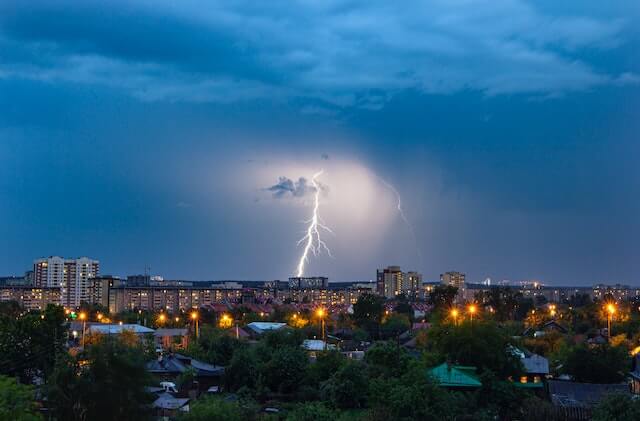 lightning strike over a city, in need of a powerful supply