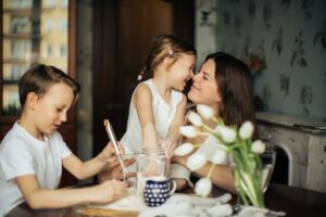 family spends time together indoors with spring flowers