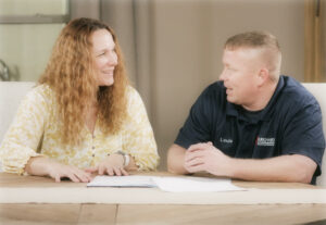 salesperson meets with homeowner about new air conditioning