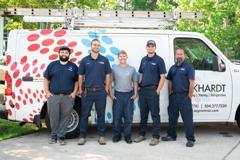 Burkhardt HVAC technicians next to work truck