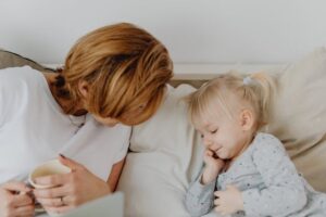 mother and child snuggle on couch