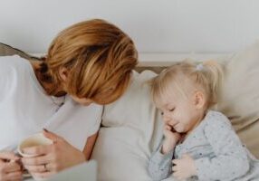 mother and child snuggle on couch